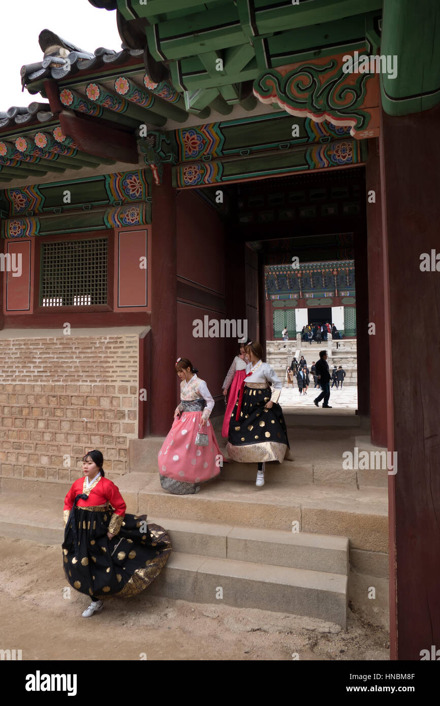Happy girls wearing hanbok, young women with traditional Korean dress at Gyeongbokgung Palace, monument. Seoul, South Korea, Asia Stock Photo