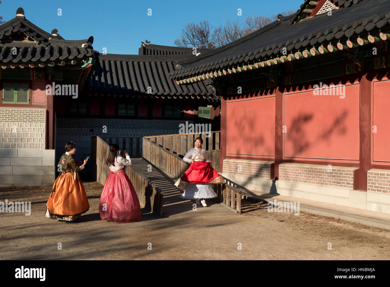 Happy girls wearing hanbok, young women with traditional Korean dress at Changdeokgung Palace, monument. Seoul, South Korea, Asia Stock Photo