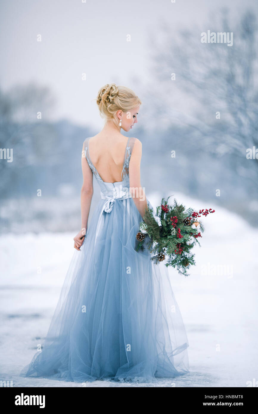Bride among snowy landscape. She is standing. View from back. Winter  wedding outdoors Stock Photo - Alamy