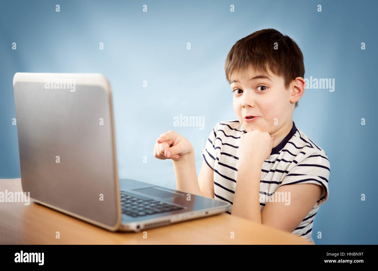 seven years old child sitting with a laptop Stock Photo Alamy