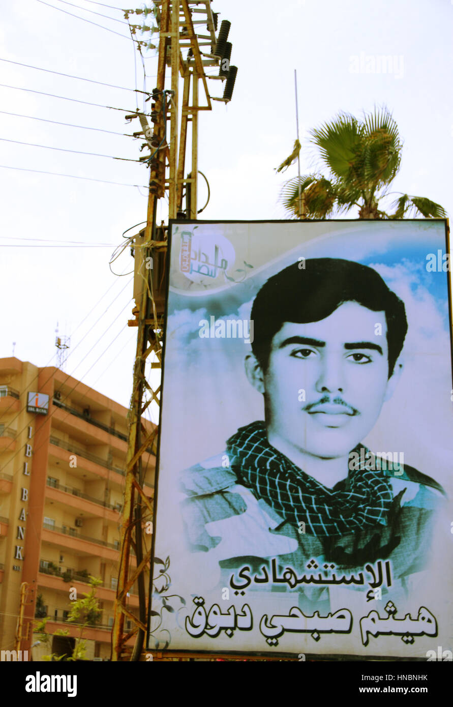 A roadside billboard bears the image of a Hezbollah fighter who died as a martyr in the war with Israel in 2006 in the south of Lebanon near Tyre. Stock Photo