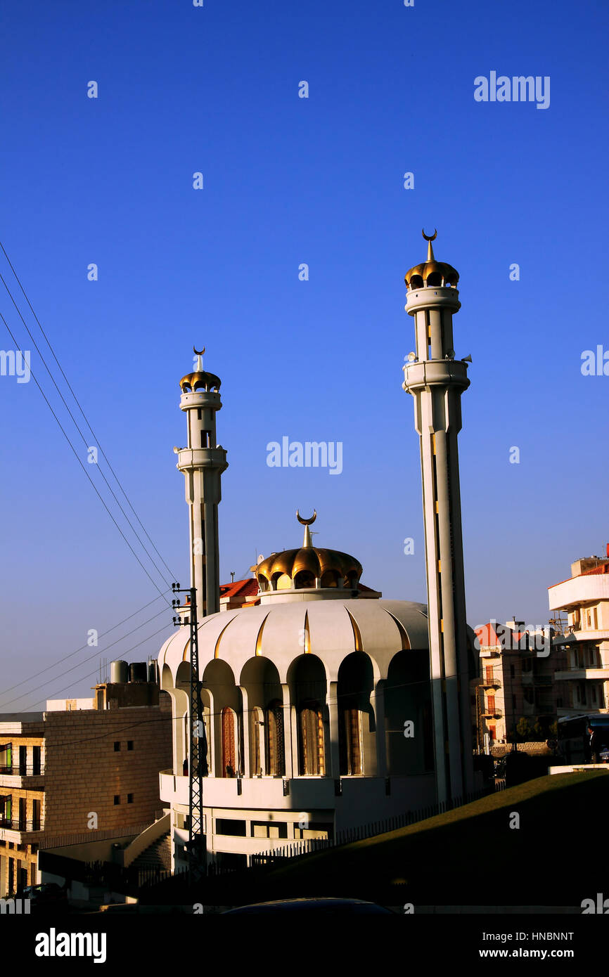 A very unusually shaped and designed mosque with crowns on its dome and minarets in the south of Beirut, Lebanon. Stock Photo