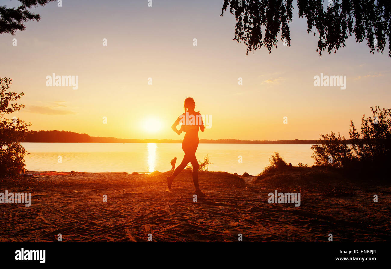 girl at sunset by the lake Stock Photo - Alamy