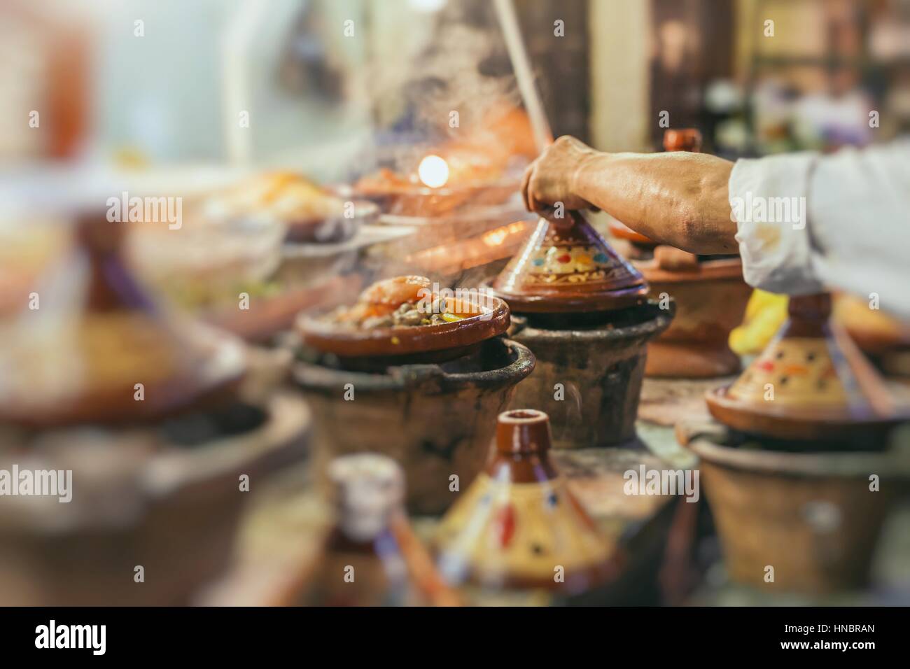 Selection of very colorful Moroccan tajines (traditional casserole dishes) - Stock Image