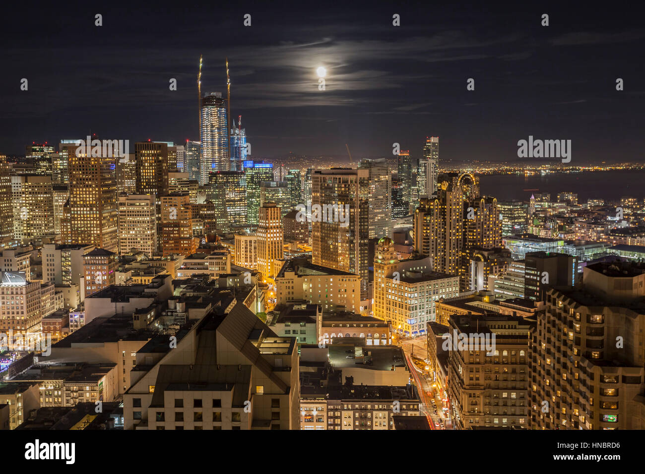 San Francisco, California, USA - January 13, 2017:  Downtown night view with moon rising over San Francisco Bay. Stock Photo