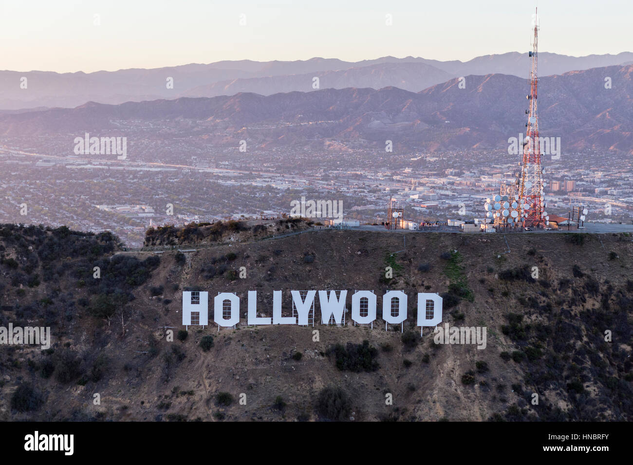 Los Angeles, California, USA - July 21, 2016:  Late afternoon aerial of the Hollywood Sign in Griffith Park with the San Fernando Valley in background Stock Photo