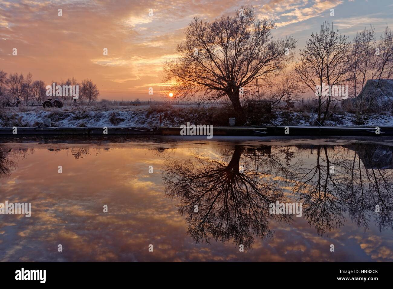 River reflections at sunset, Oldersum, Lower Saxony, Germany Stock Photo