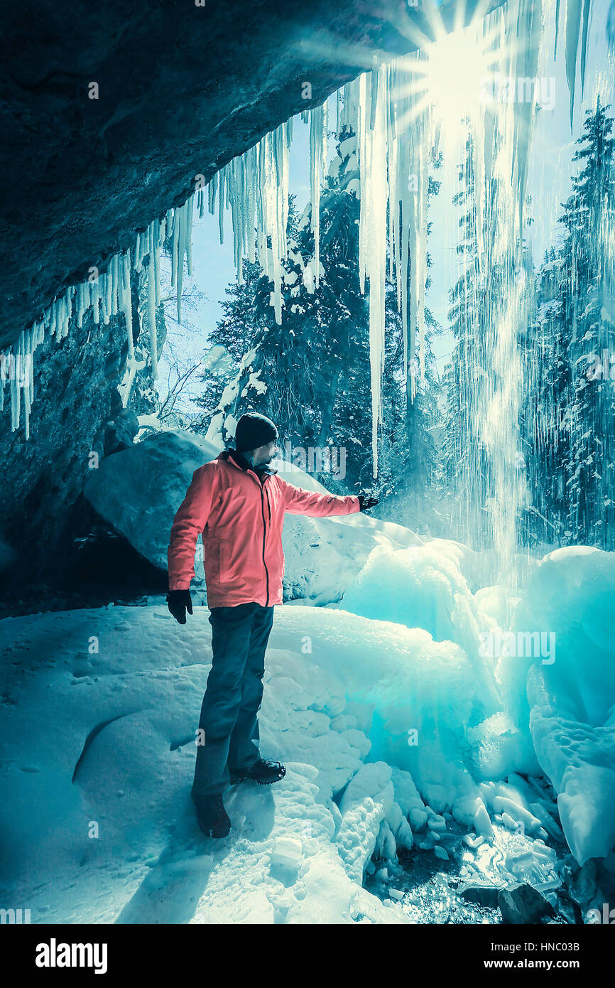 Man standing behind a frozen waterfall, Glenwood Springs, Colorado, United States Stock Photo