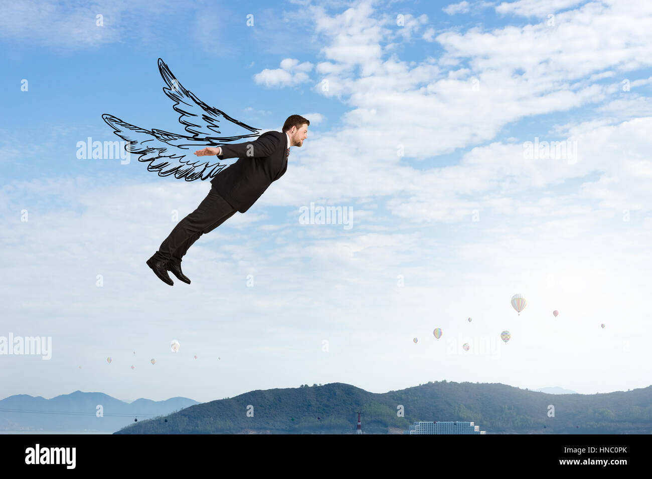 Young businessman with drawn wings flying in sky Stock Photo Alamy