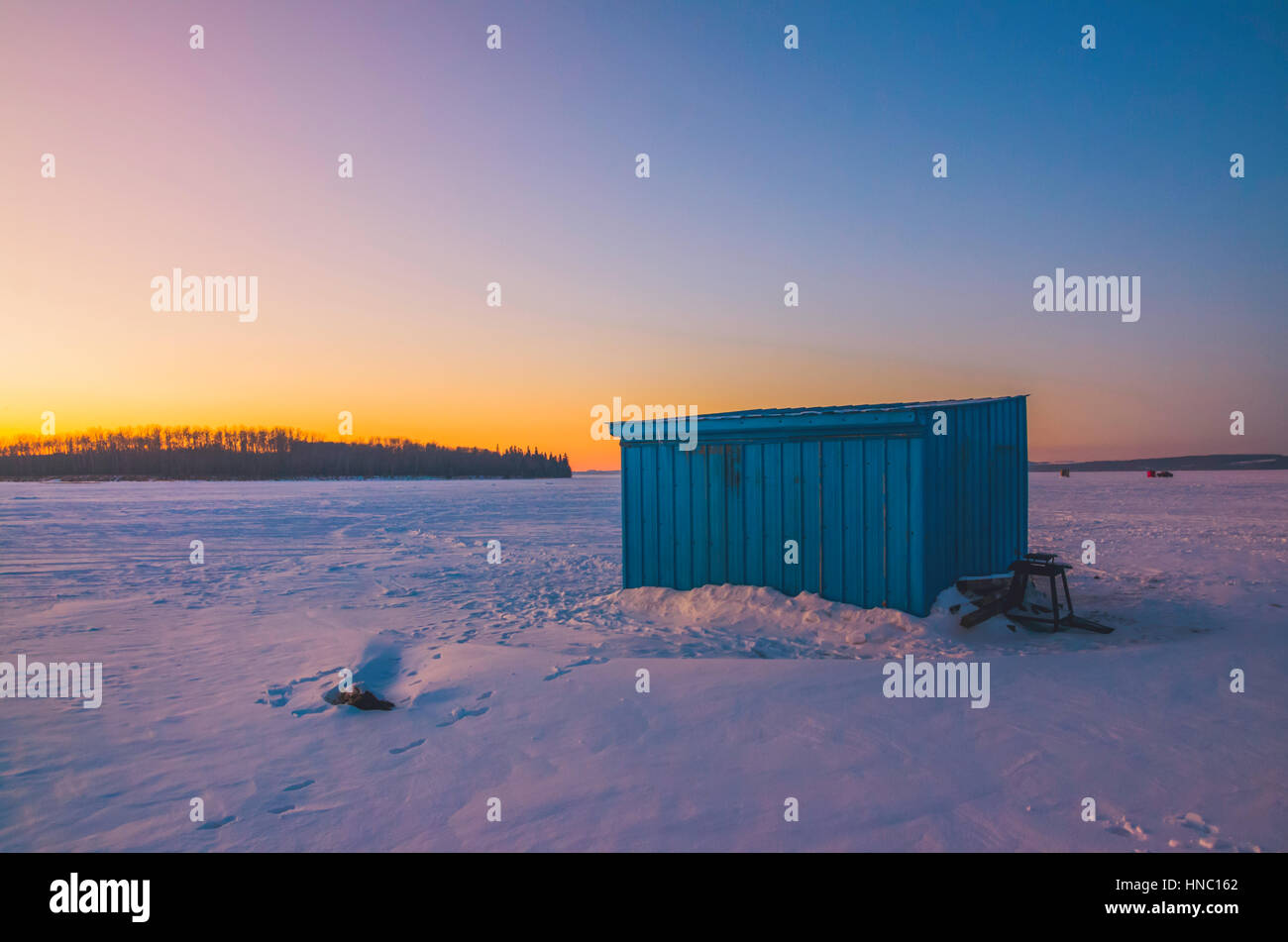 Ice shack fishing on sylvan lake, canada Stock Photo