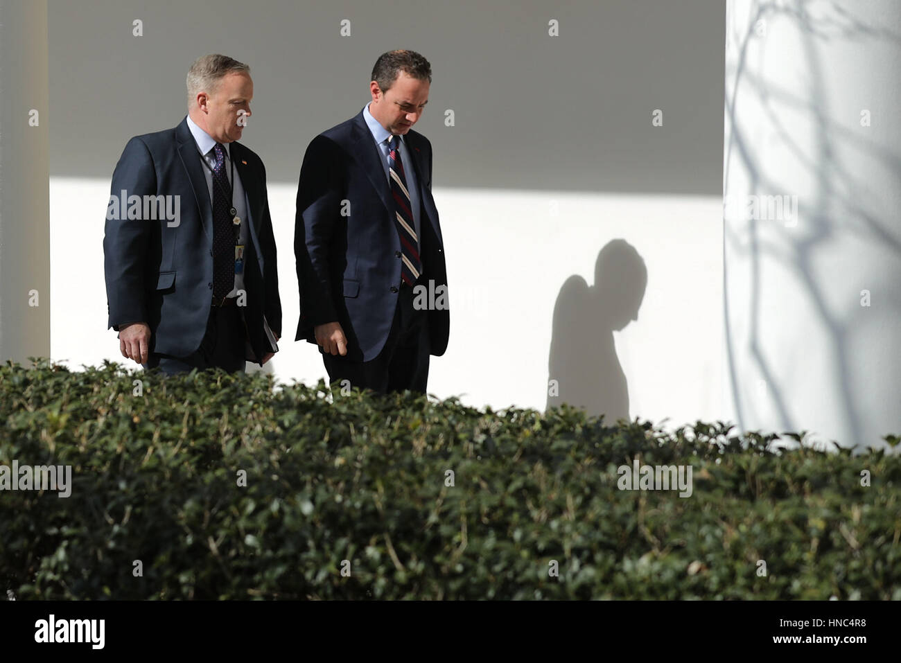 White House Press Secretary Sean Spicer (L) and White House Chief of Staff Reince Priebus walk down the West Wing Colonnade following a bilateral meeting between U.S. President Donald Trump and Japanese Prime Minister Shinzo Abe February 10, 2017 in Washi Stock Photo