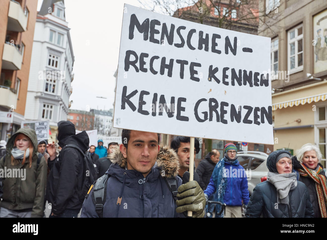 Hamburg, Germany. 11th Feb, 2017. A demonstrator holding up a sign that ...