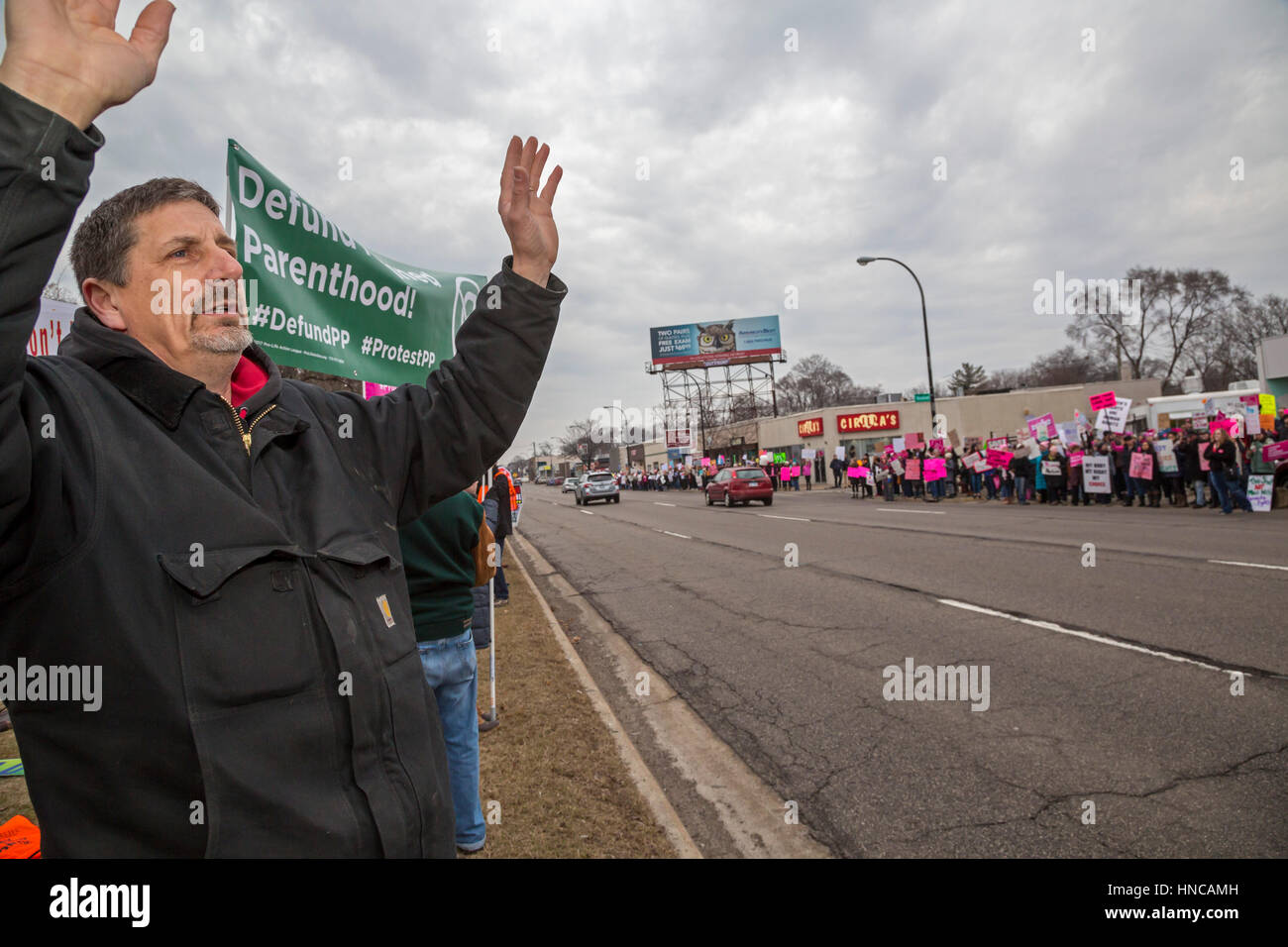 Ferndale, Michigan, USA. 11th February 2017. Supporters of Planned Parenthood (right side of street) far outnumbered opponents as both sides rallied outside Planned Parenthood clinics in metro Detroit. The Trump administration says it will deny federal funds to Planned Parenthood for women's health services because the agency helps some women obtain legal abortions. Credit: Jim West/Alamy Live News Stock Photo