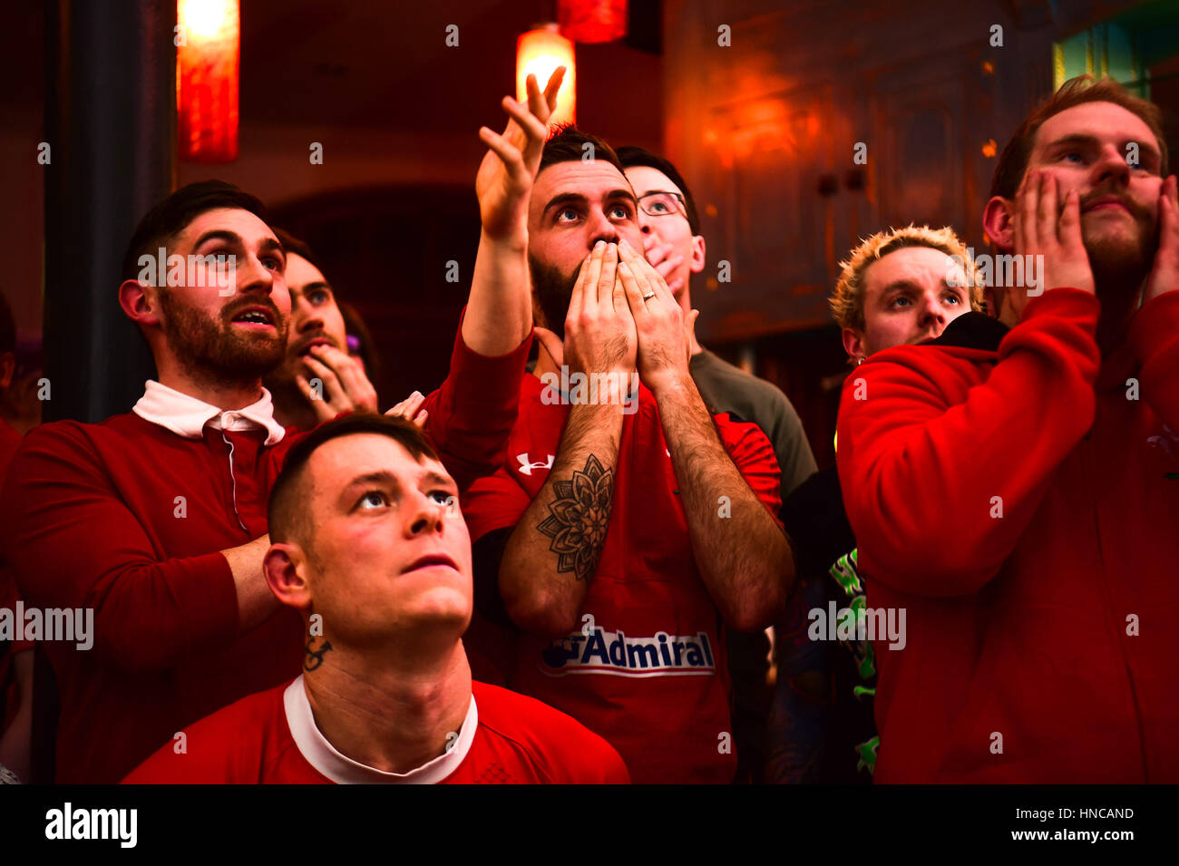 UK Sport: Disconsolate Rugby fans watching Wales playing against  England in the Six Nations rugby international match (live on television  from the Principality Stadium Cardiff) in the Castle Hotel pub in Aberystwyth Wales UK.   Despite being ahead for most of the game, a late English try  gave England the victory  by 21  points to 16 Stock Photo