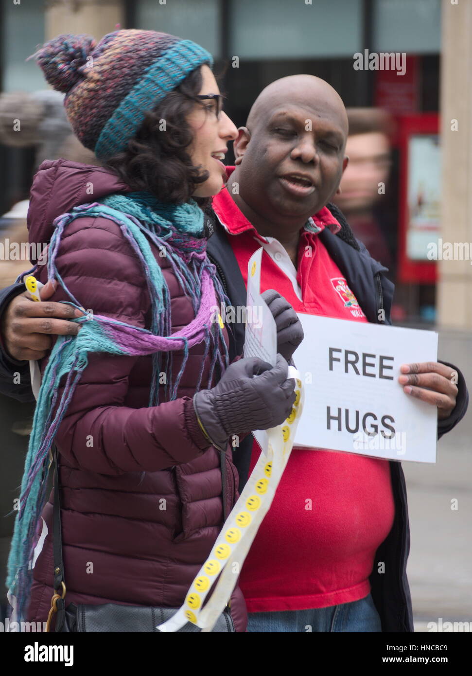 Cardiff, Wales, United Kingdom, 11th Feb, 2017. Rugby fans involved in a campaign of "free hugs" in Queen street in Cardiff. The Six Nations rugby match between Wales and England had a strong importance because of the historical rivality between the two fandoms. Stock Photo