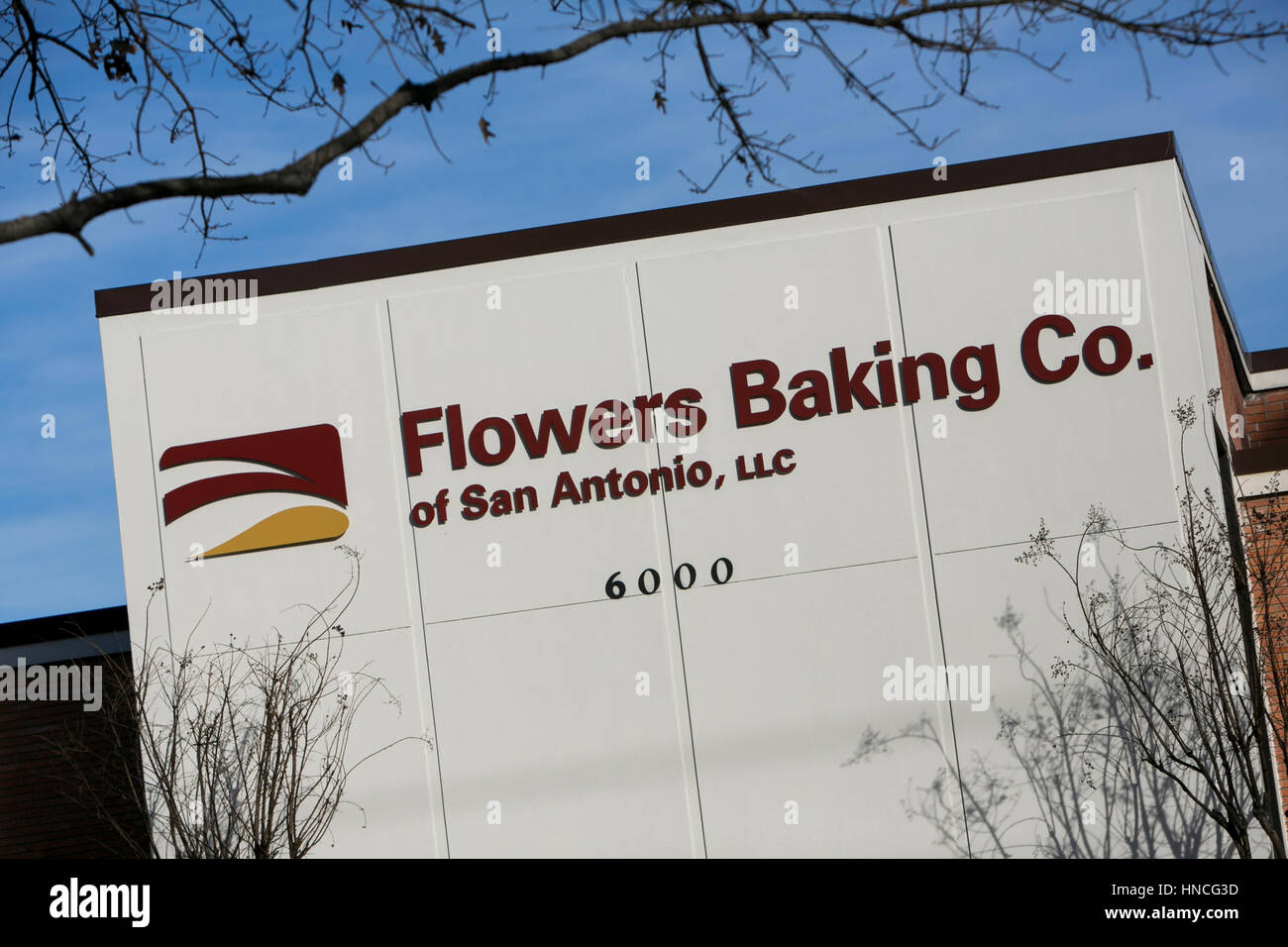 A logo sign outside of a facility occupied by the Flowers Baking