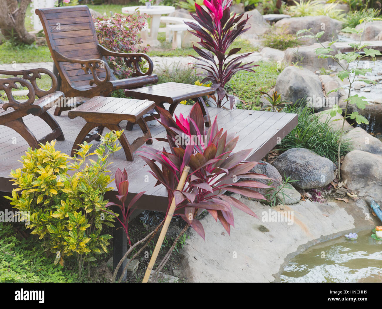 two table and chairs in garden on wood floor Stock Photo - Alamy