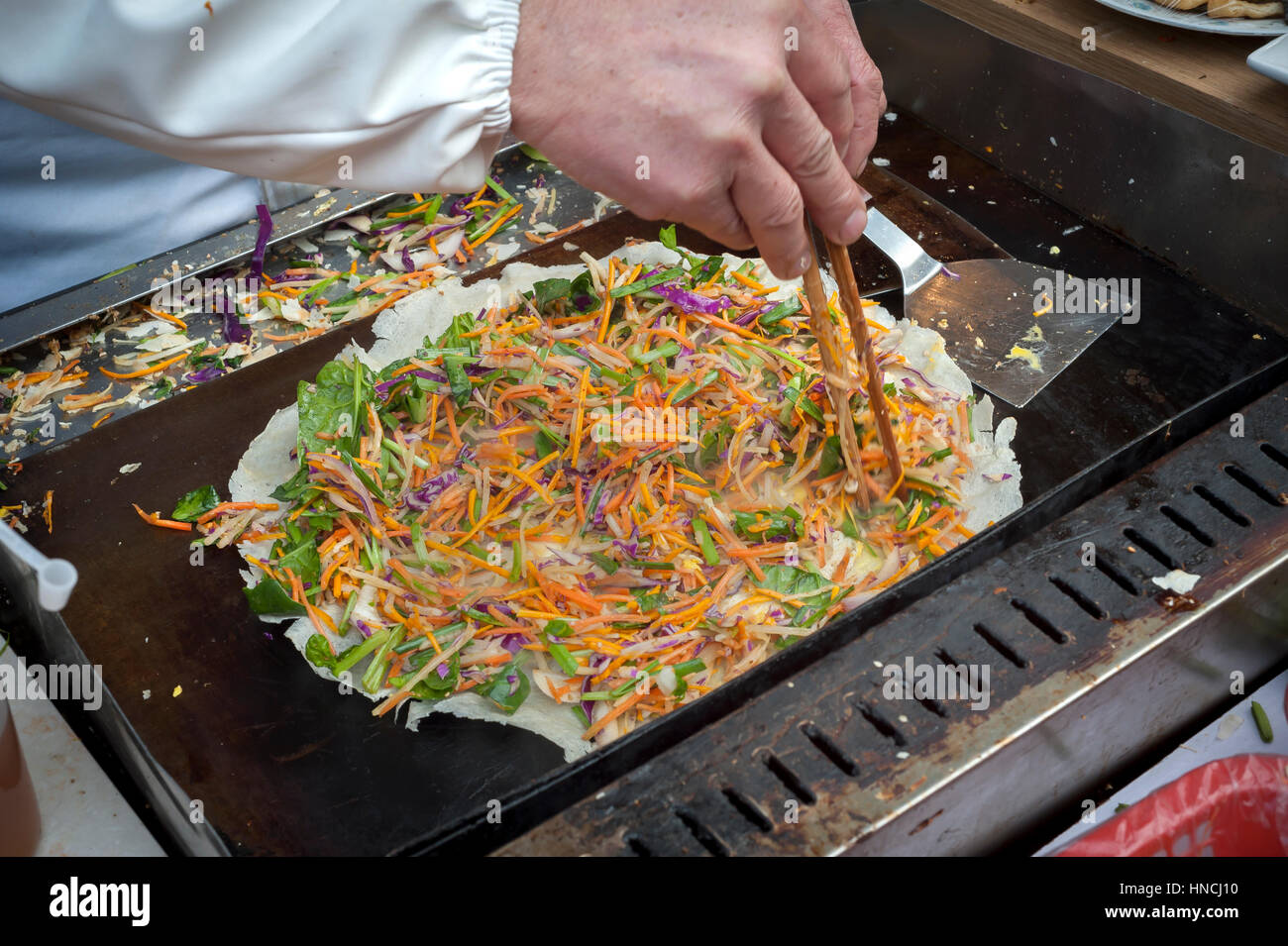 Chinese Jianbing pancake being prepared at a Shanghai street market Stock Photo