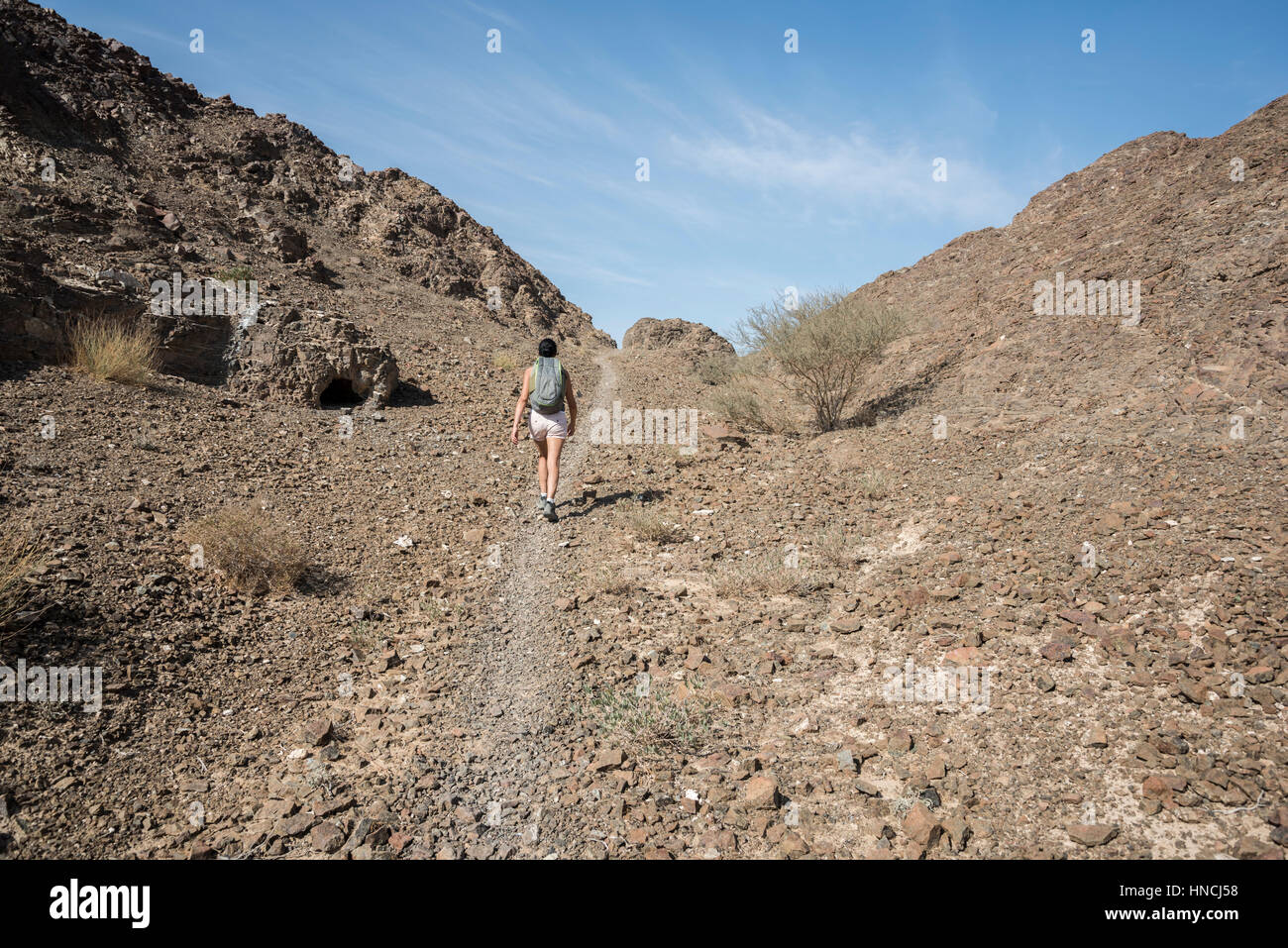 Woman trekking in a Wadi (Dry mountains) in the middle east Stock Photo