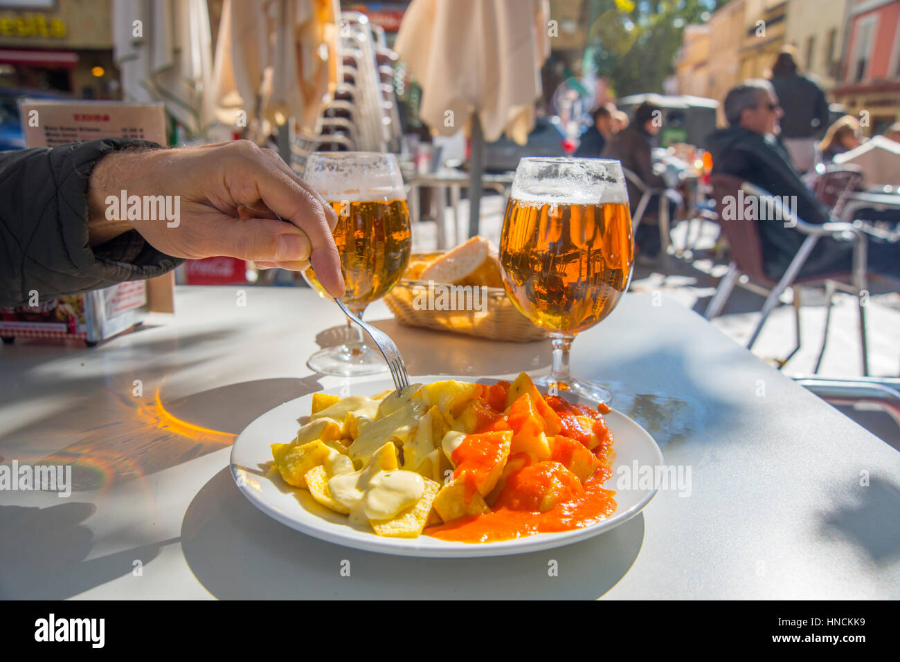 Patatas bravas and Patatas alioli with two glasses of beer in a terrace. Madrid, Spain. Stock Photo