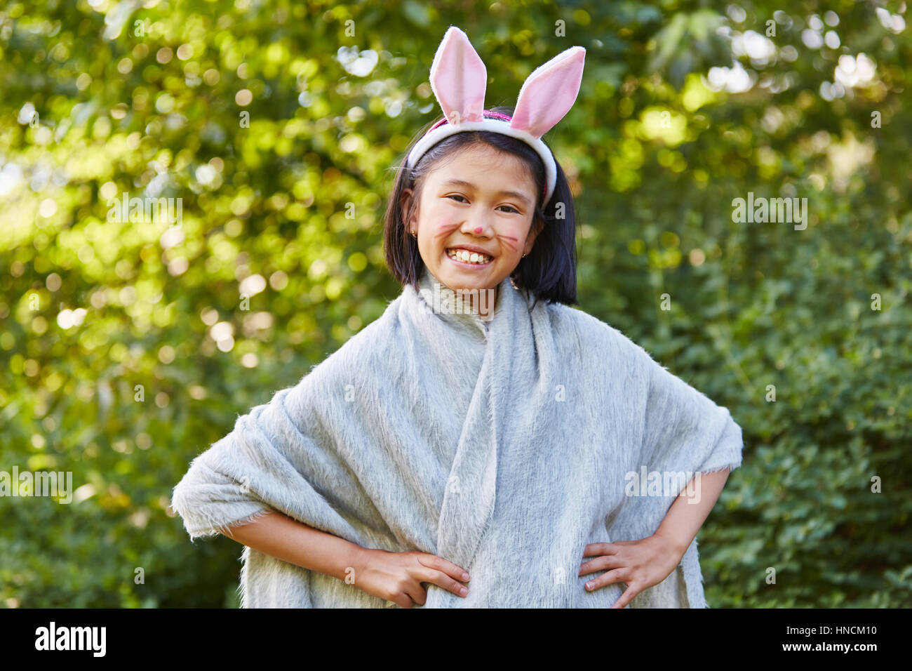 Girl has fun playing bunny in school play in carnival Stock Photo