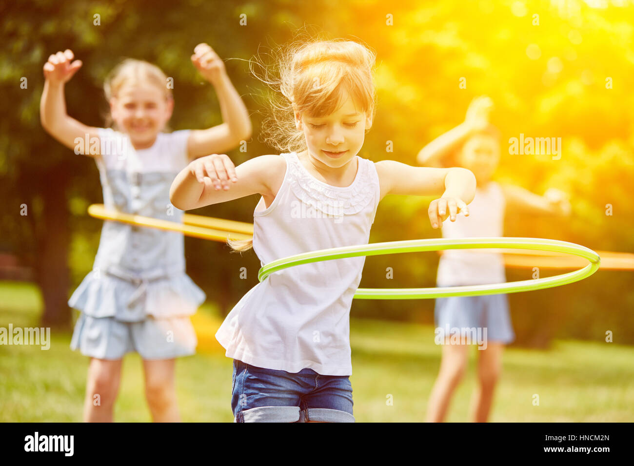 Happy interracial group of kids playing in summer Stock Photo