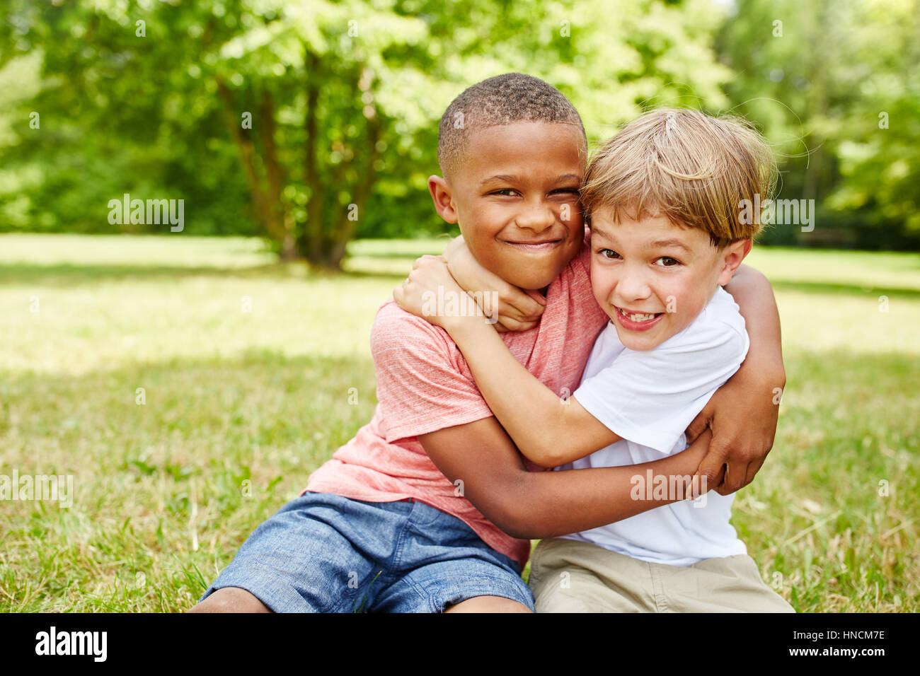 Two kids as friends fighting with each other for fun Stock Photo