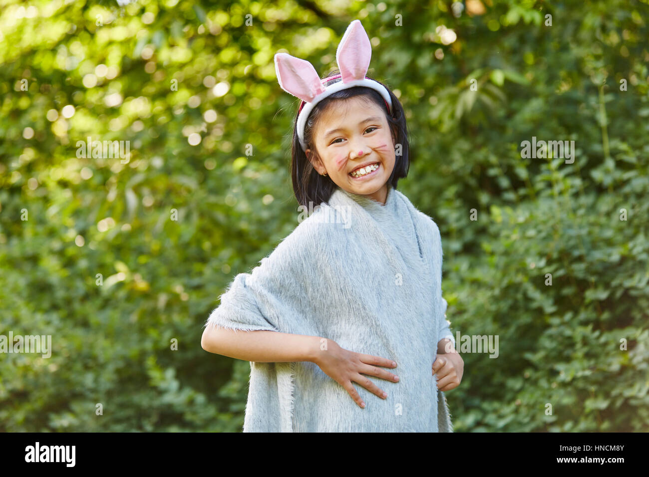 Asian girl in creative bunny costume having fun in carnival school play Stock Photo