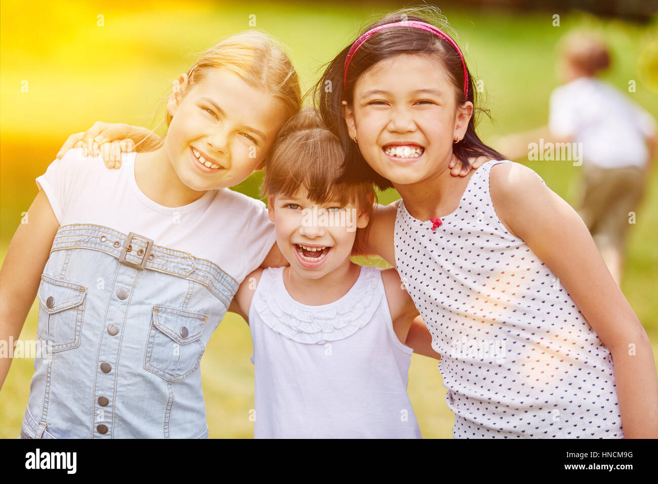 Happy group of girls in kindergarden in summer Stock Photo