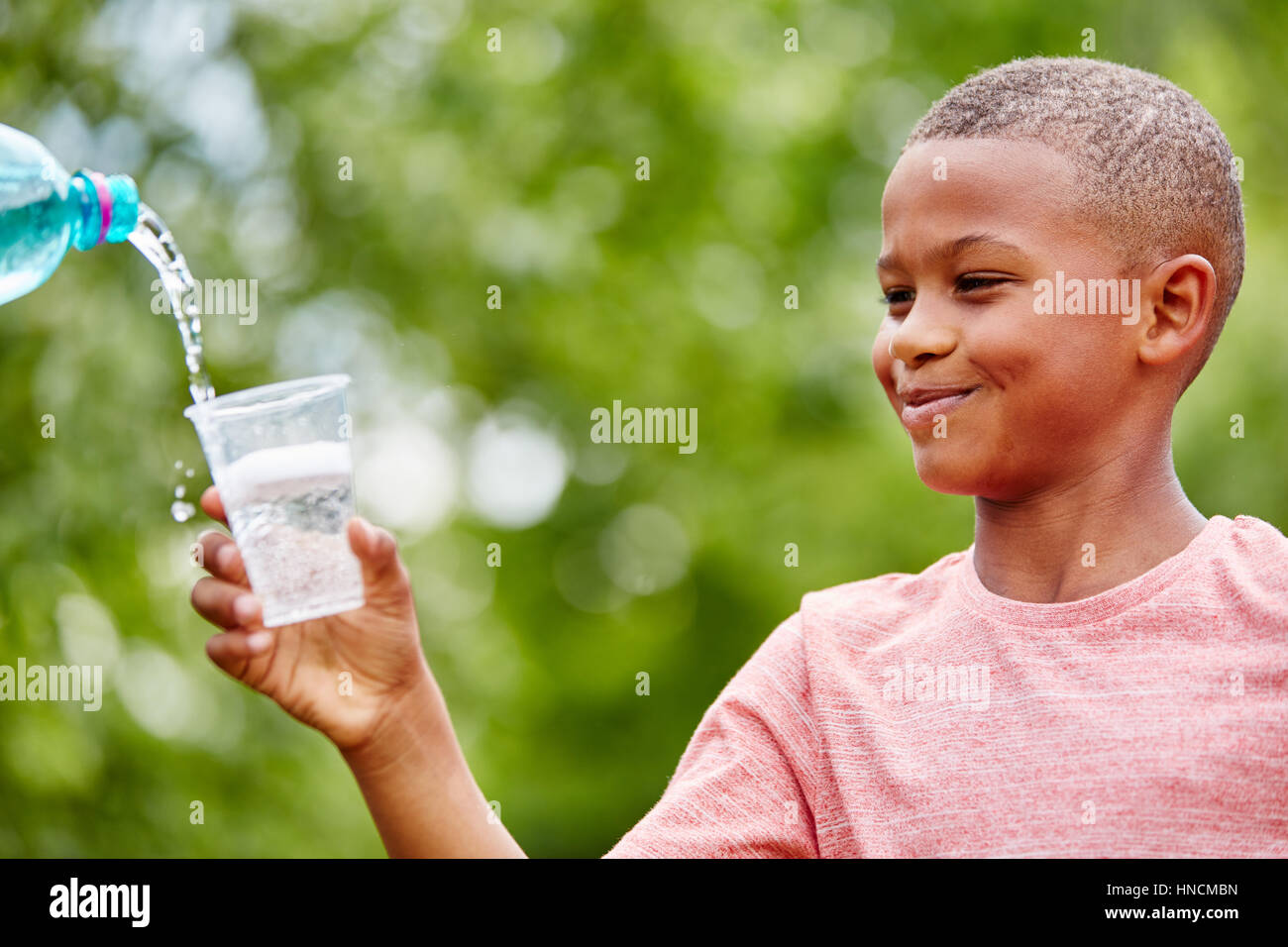 African child holding plastic cup excited about drinking water Stock Photo Alamy