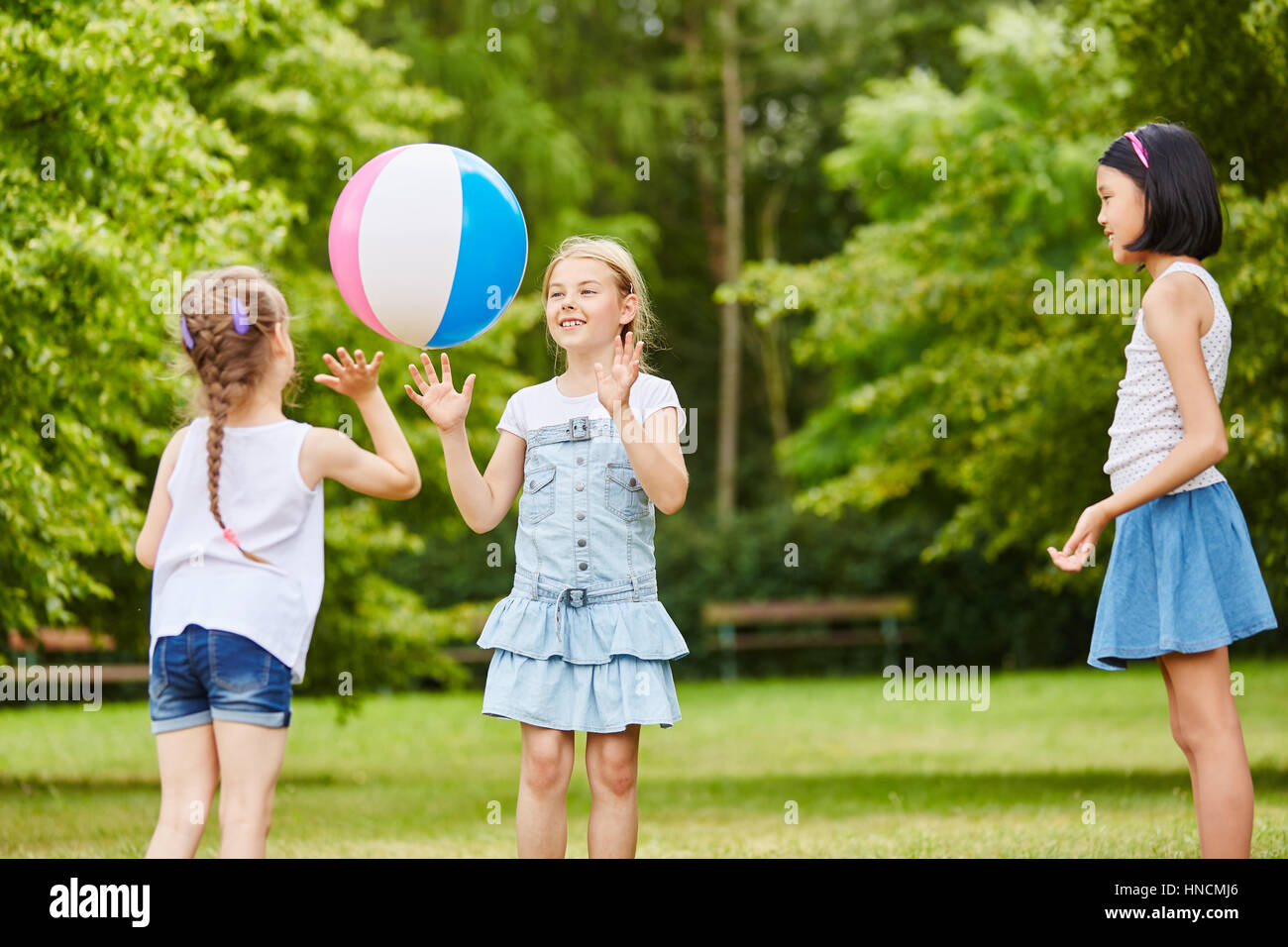 Three girls playing catch and throw together with ball Stock Photo Alamy