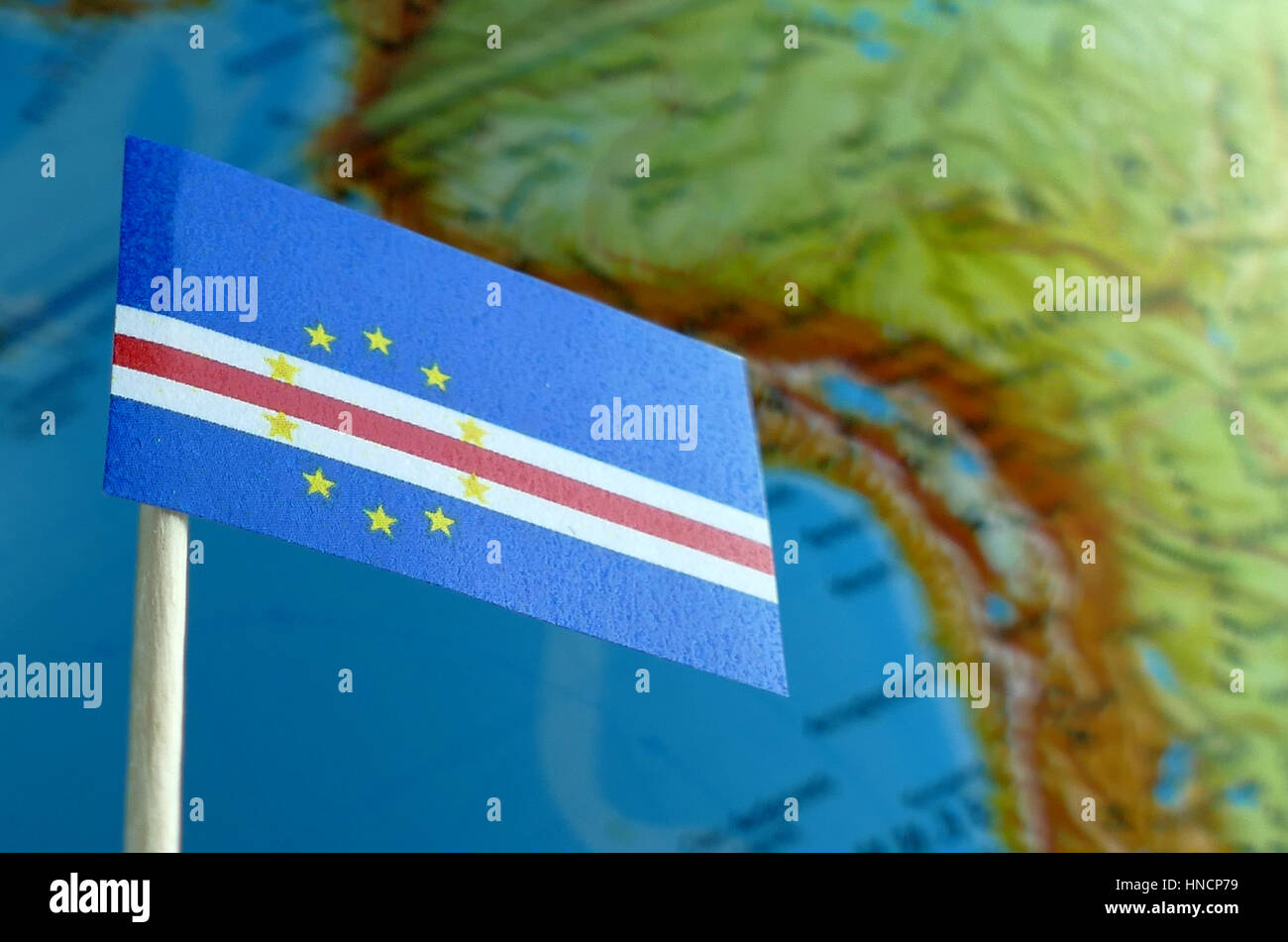 Cape Verde flag with a globe map as a background macro Stock Photo