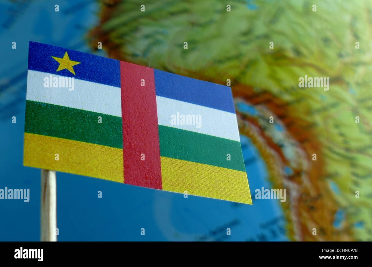 Central African Republic flag with a globe map as a background macro Stock Photo