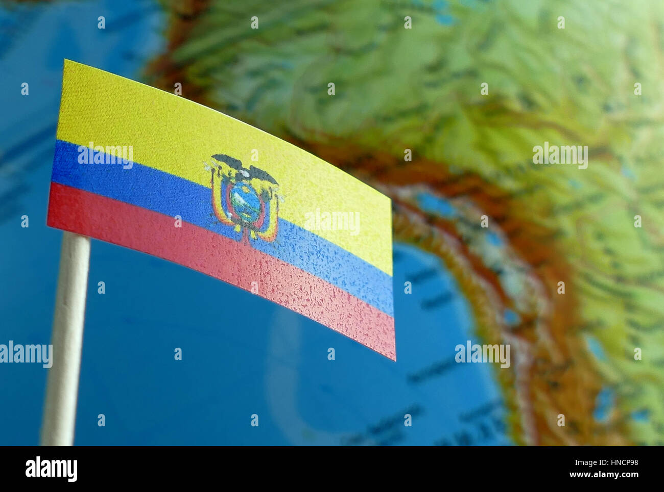 Ecuadorean flag with a globe map as a background macro Stock Photo