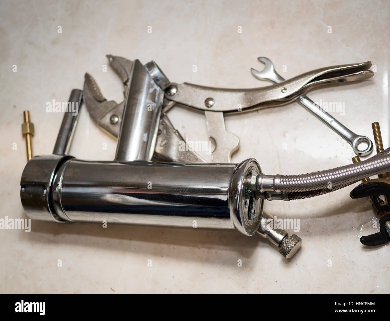 Pile of metal tools and a tap to illustrate DIY (Do It Yourself) plumbing at home Stock Photo