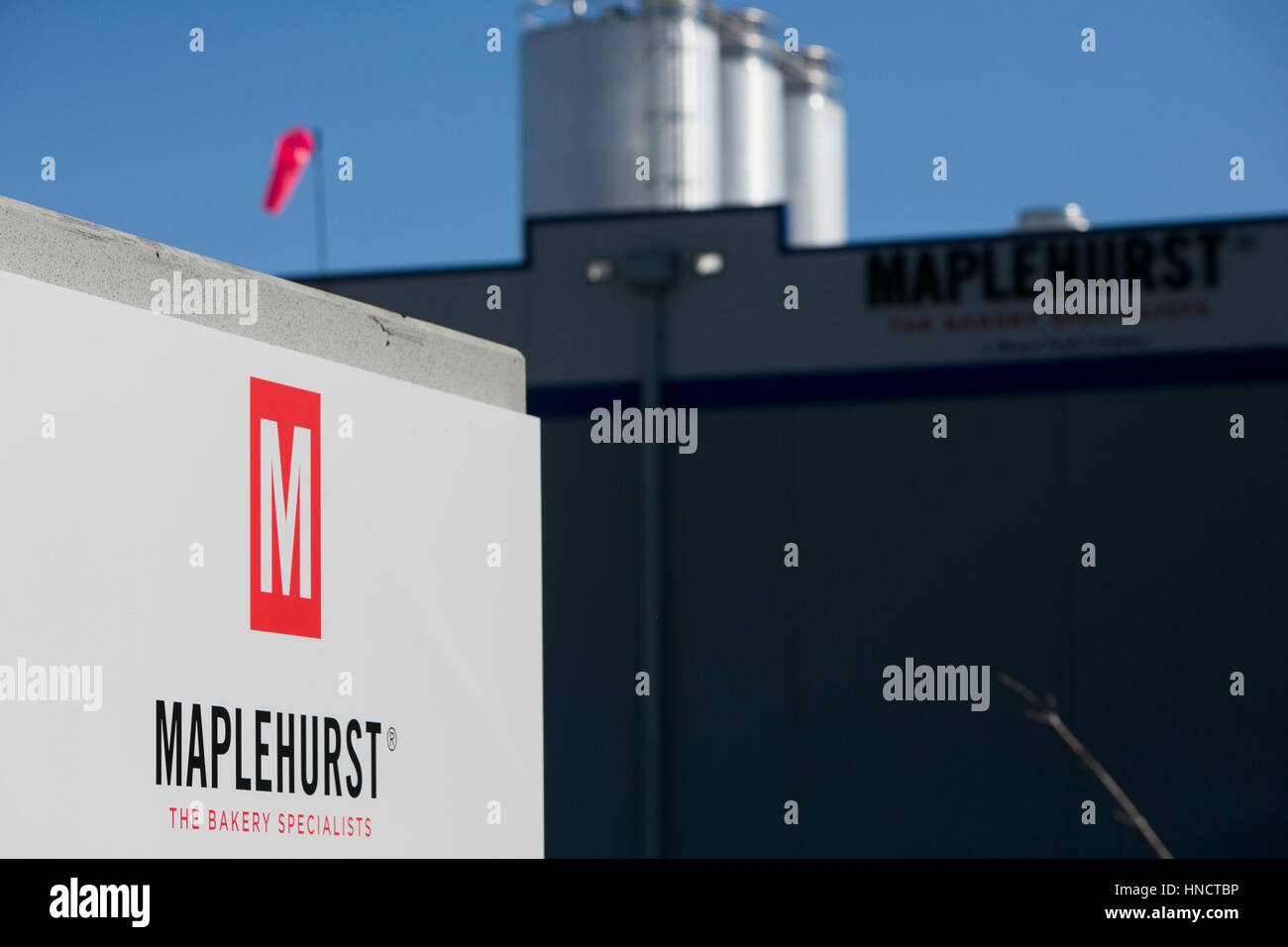 A logo sign outside of a facility occupied by Maplehurst Bakeries in