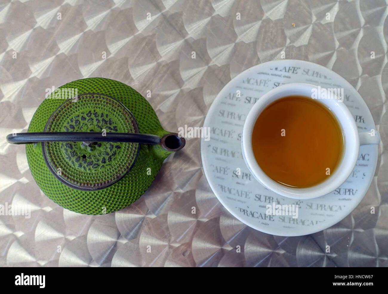 Cup of peppermint tea with teapot in Spanish cafe Stock Photo