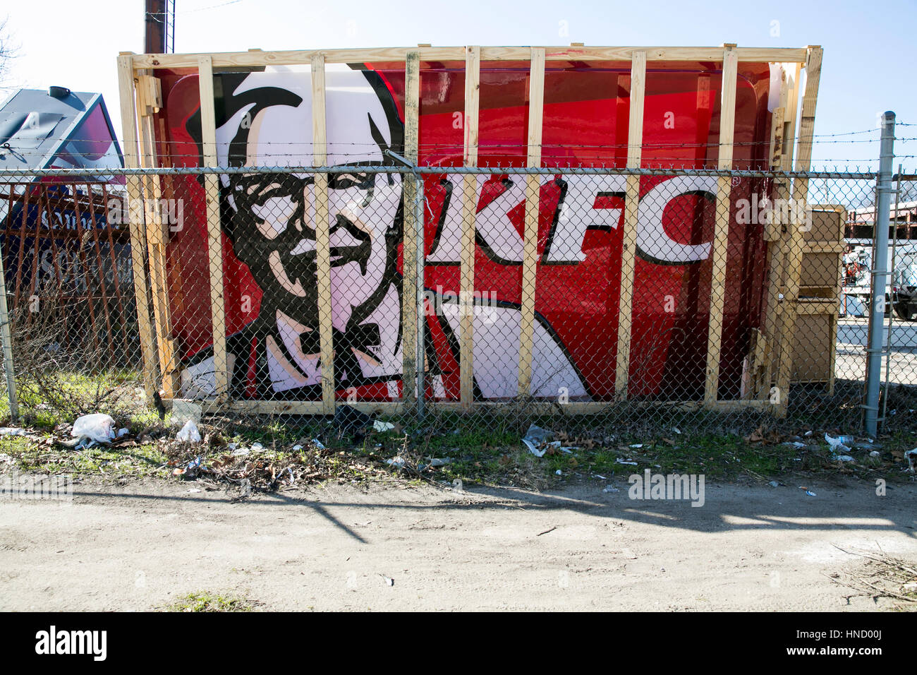 A Kentucky Fried Chicken (KFC) restaurant sign leaning against a fence in Memphis, Tennessee on February 5, 2017. Stock Photo