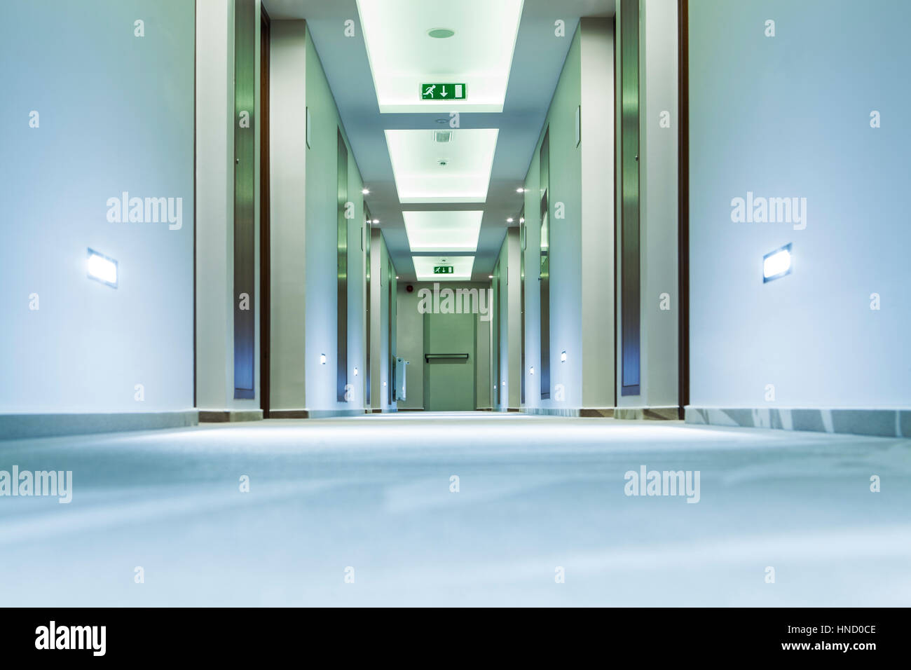 Picture of Hotel corridor from floor view pointing the exit emergency door Stock ...
