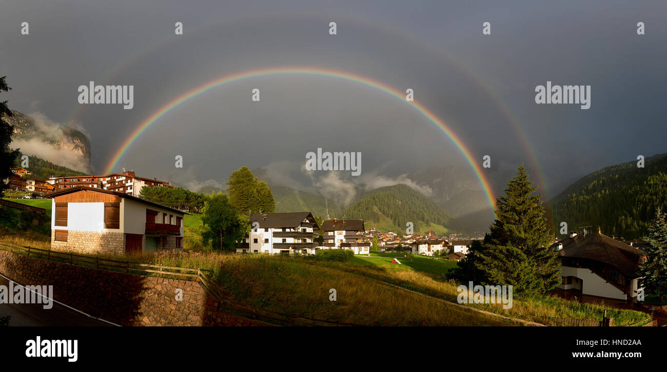 Double rainbow over the village of Selva di Val Gardena in summer season, Trentino-Alto Adige - Dolomites Stock Photo