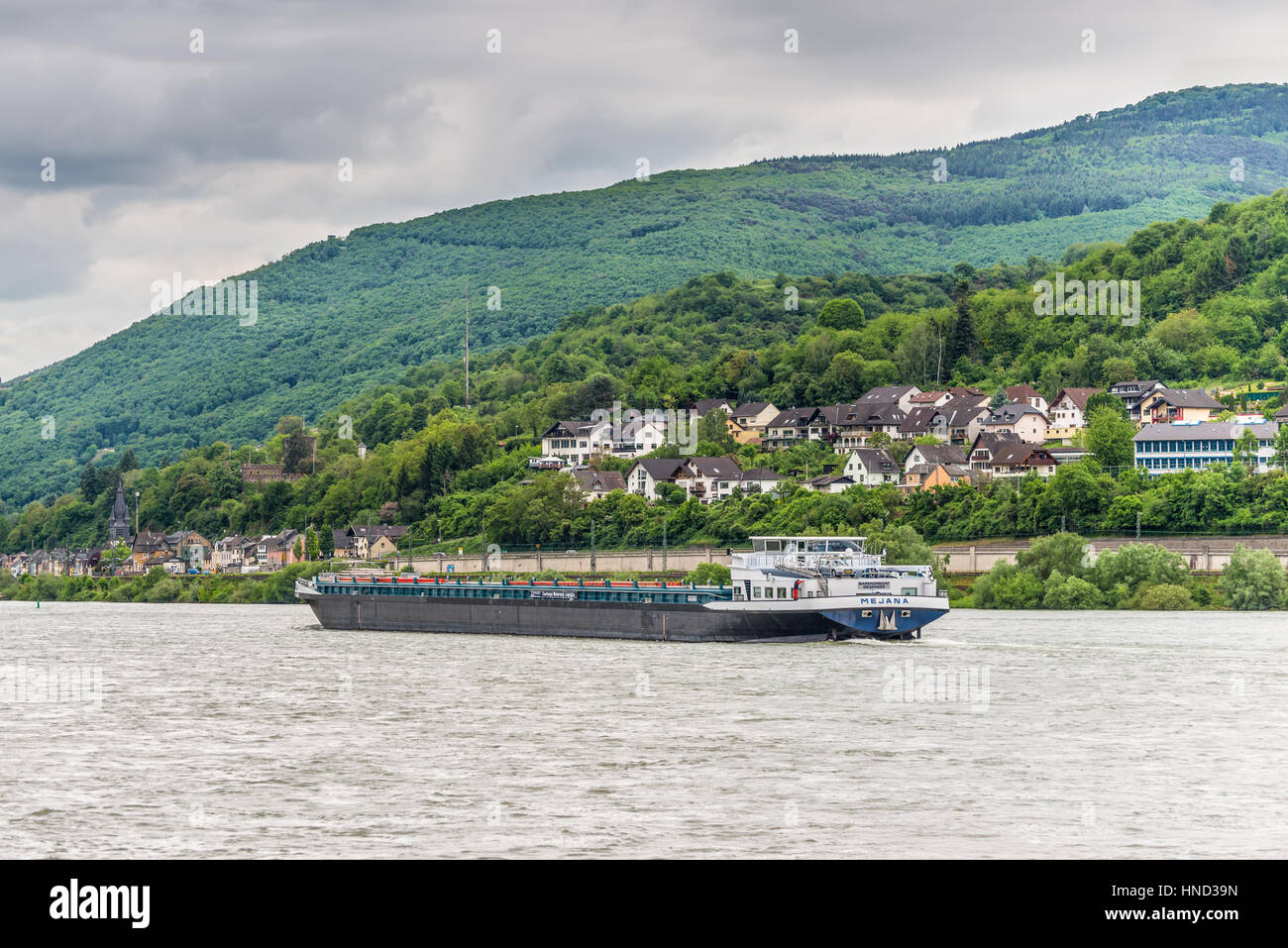 Niederheimbach, Germany - May 23, 2016: Motor Container Barge Mejana on the Rhine River near Niederheimbach in cloudy weather, Rhine Valley, UNESCO Wo Stock Photo