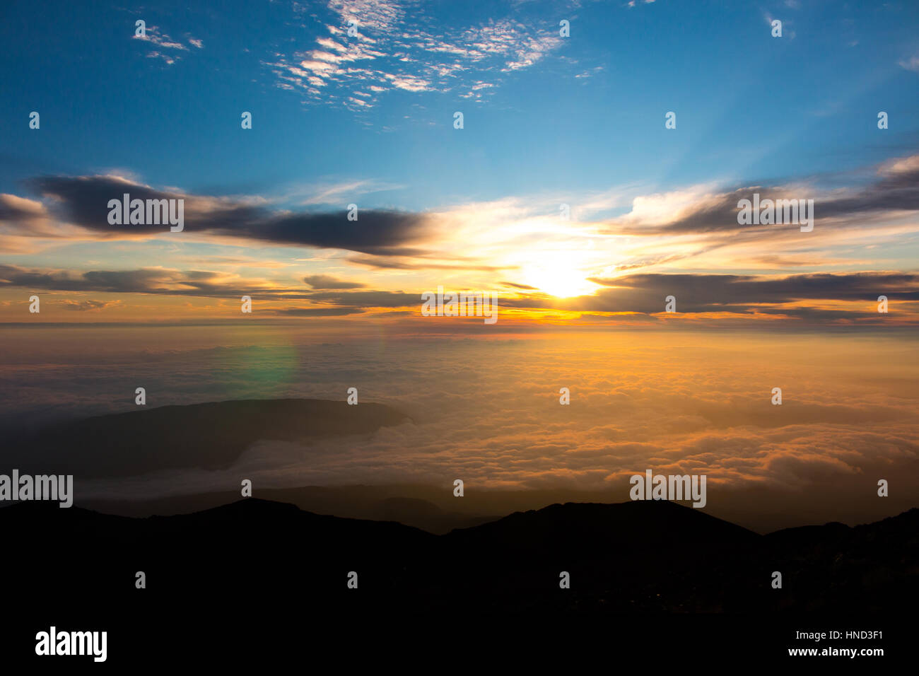 La Reunion island Piton des Neiges volcano sunrise with clouds summit