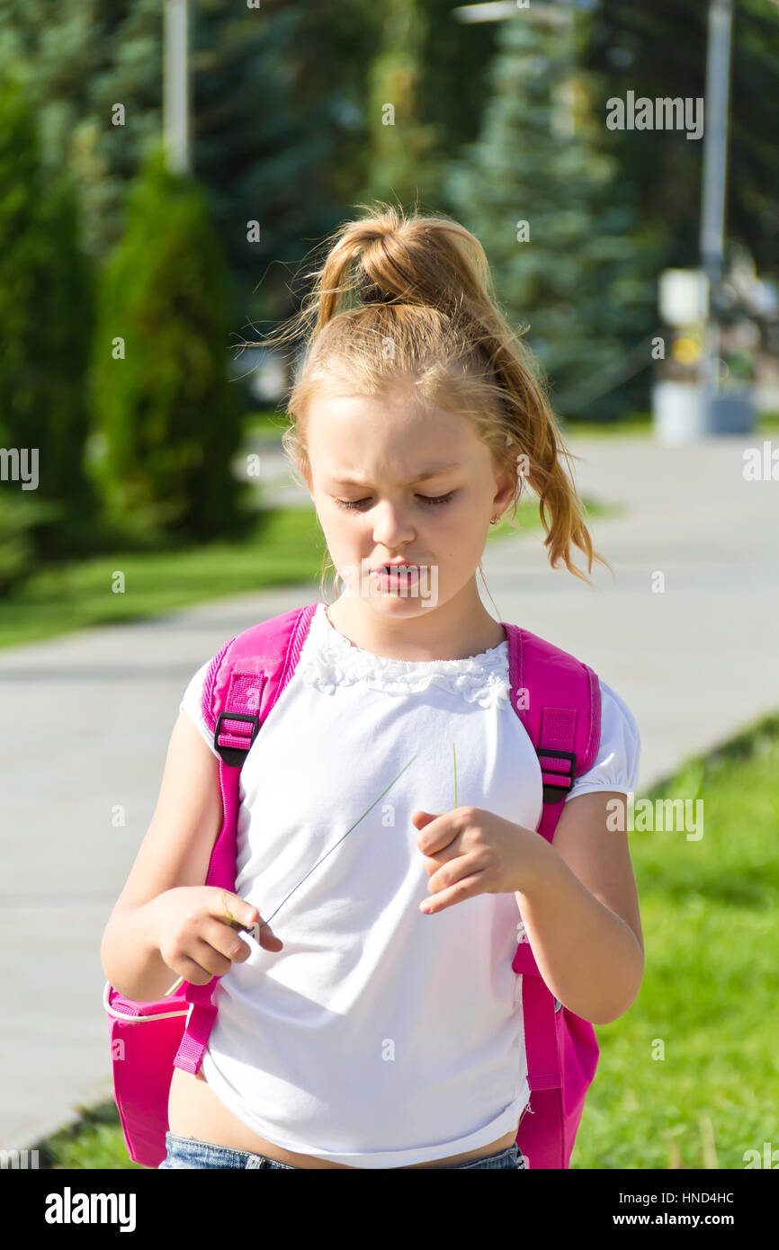 Cute girl go to school with pink knapsack Stock Photo - Alamy