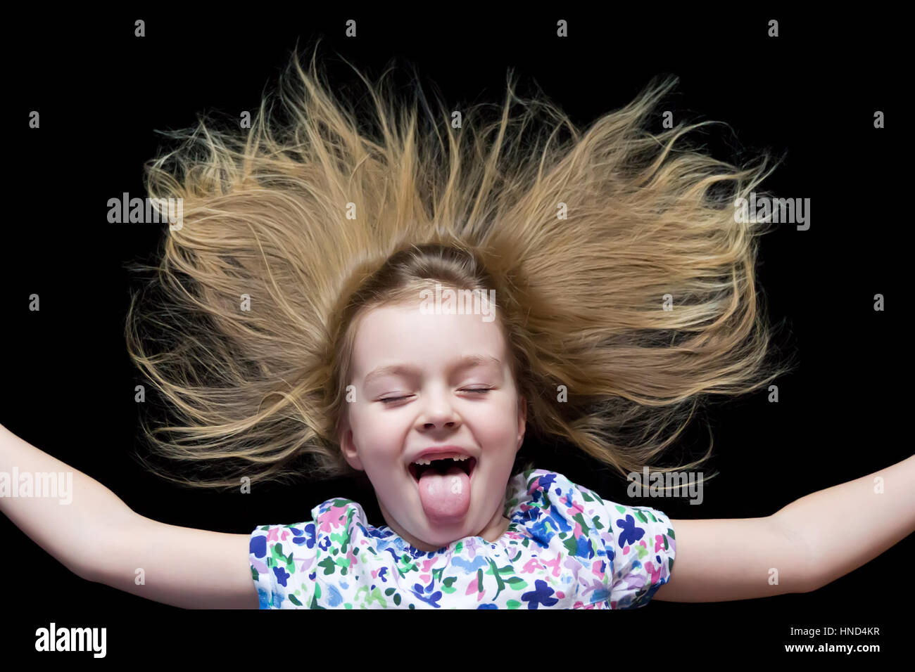 Girl makes faces imitate witch and put out tongue Stock Photo