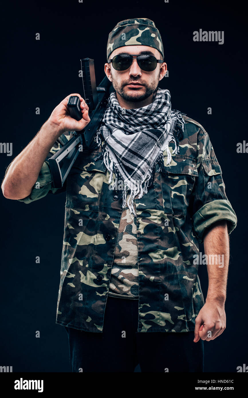 Portrait of armie forces with weapon in hands on black background Stock Photo