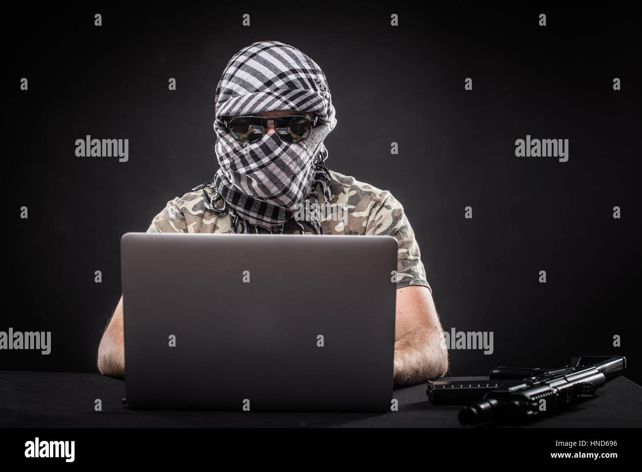 Terrorist working on his computer. Concept about international crisis ...