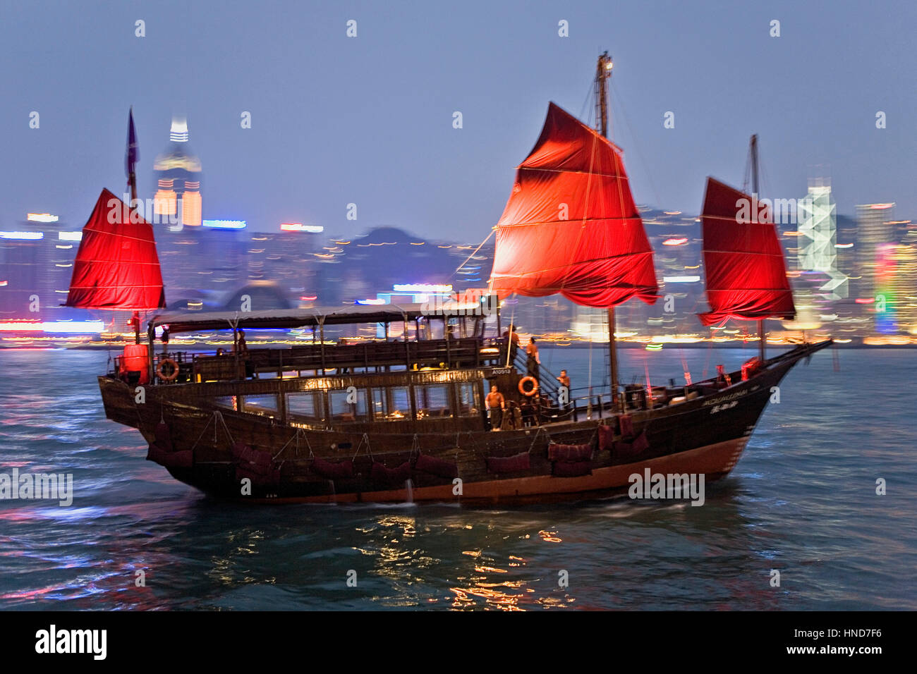 Traditional Sailing boat in Victoria Harbour with City Skyline in the Background,Hong Kong, China Stock Photo