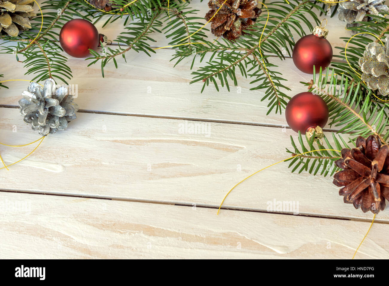 Christmas decoration with branches from fir cones and toys on white ...