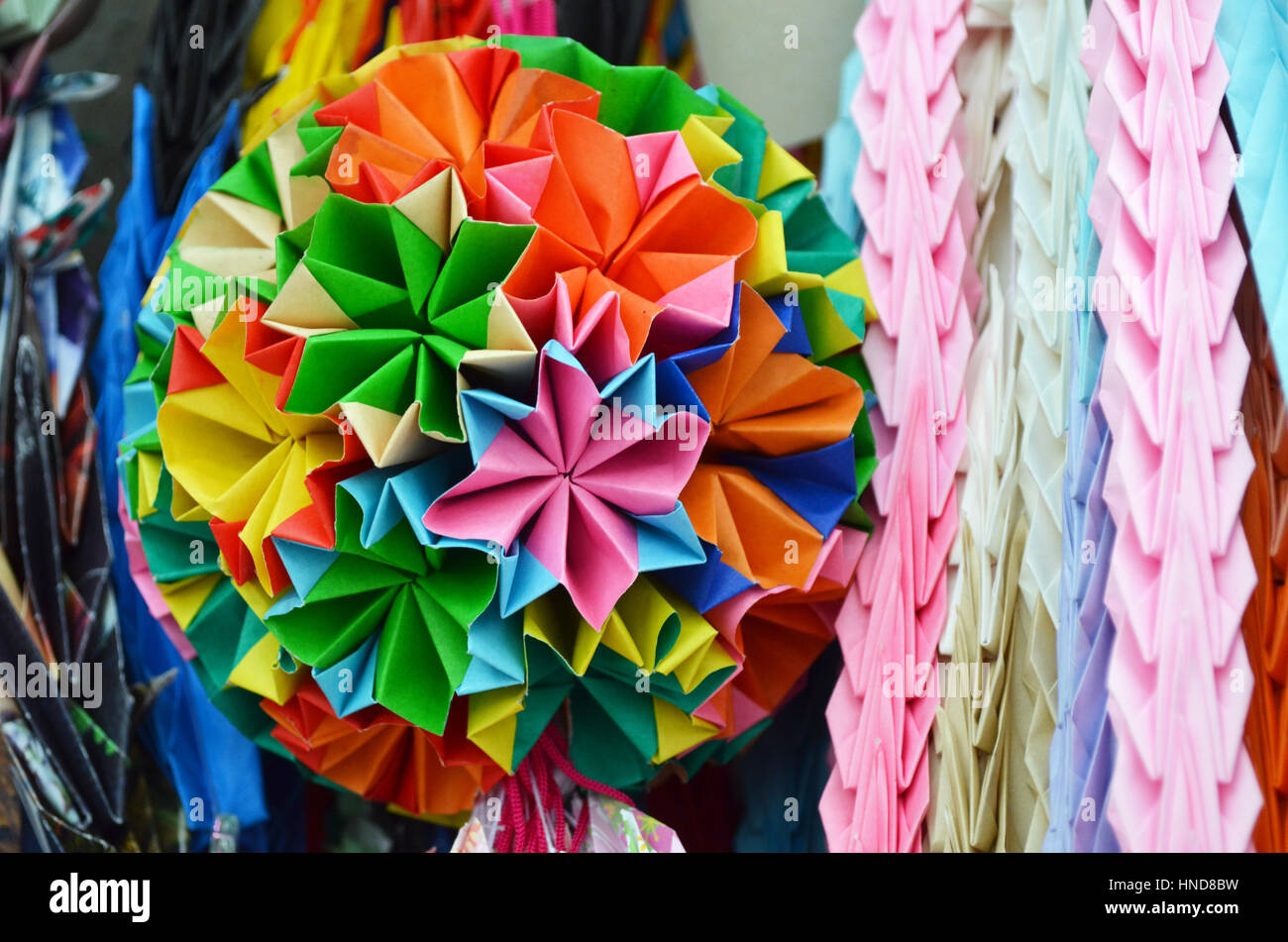 Handmade colourful origami paper cranes and floral ball in Hiroshima Peace Park, Japan Stock Photo