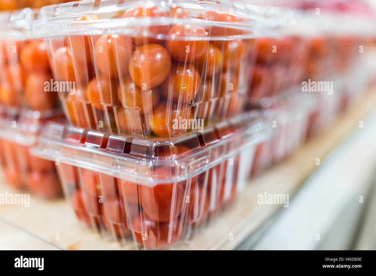 Cherry tomatoes in plastic boxes on display Stock Photo Alamy